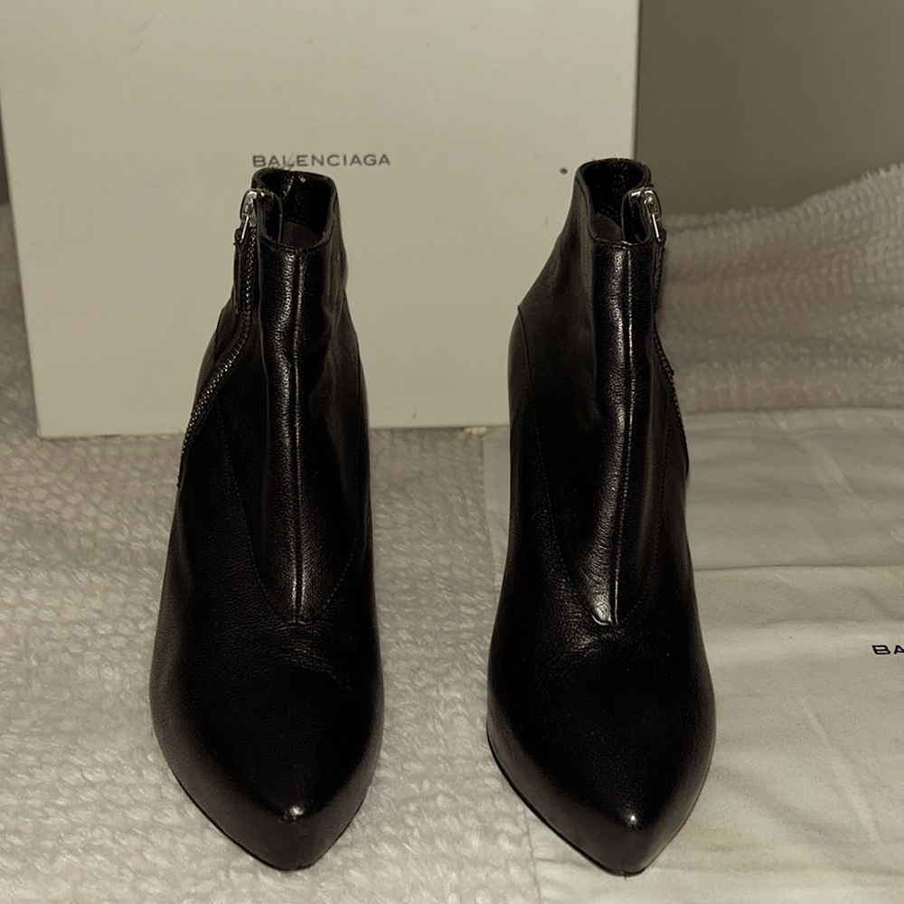 Balenciaga short black leather booties with silver zipper facing in.